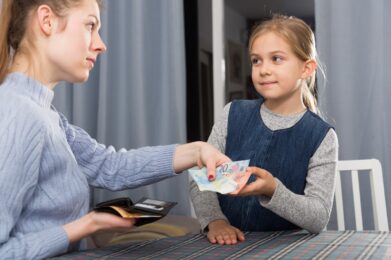 woman giving pocket money her daughter